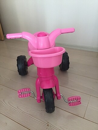 Dolu. Üç tekerlekli pembe bisiklet